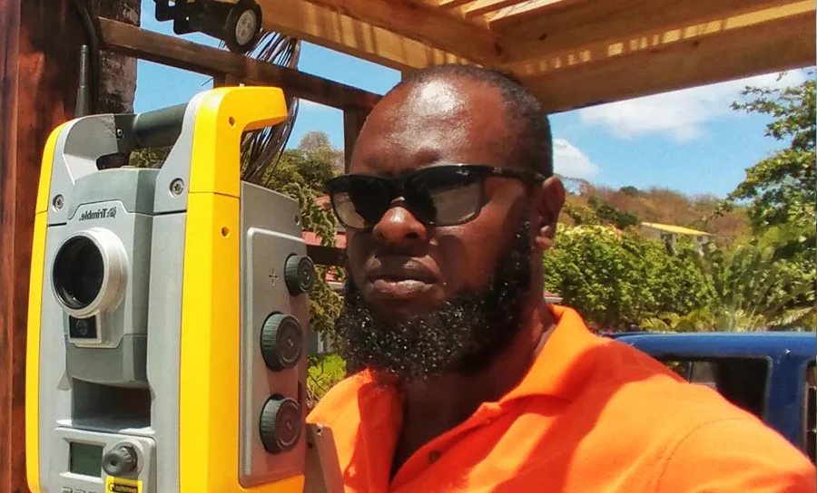 Alec Joseph, owner and lead surveyor at Akriveia Surveying, working with a Trimble total station