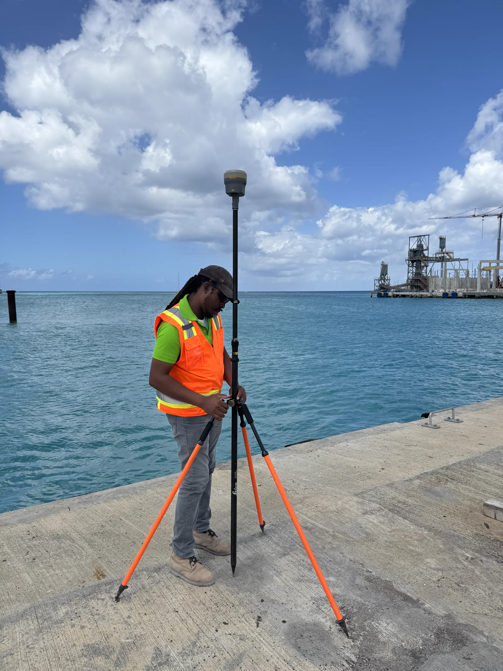 Surveyor operating a GNSS rover at a Barbados port berth