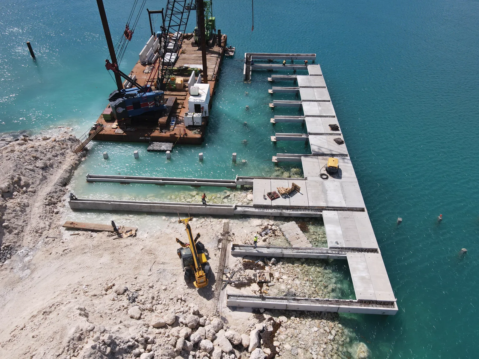 Aerial view of cargo and shallow-draught berth works over turquoise water in Barbados